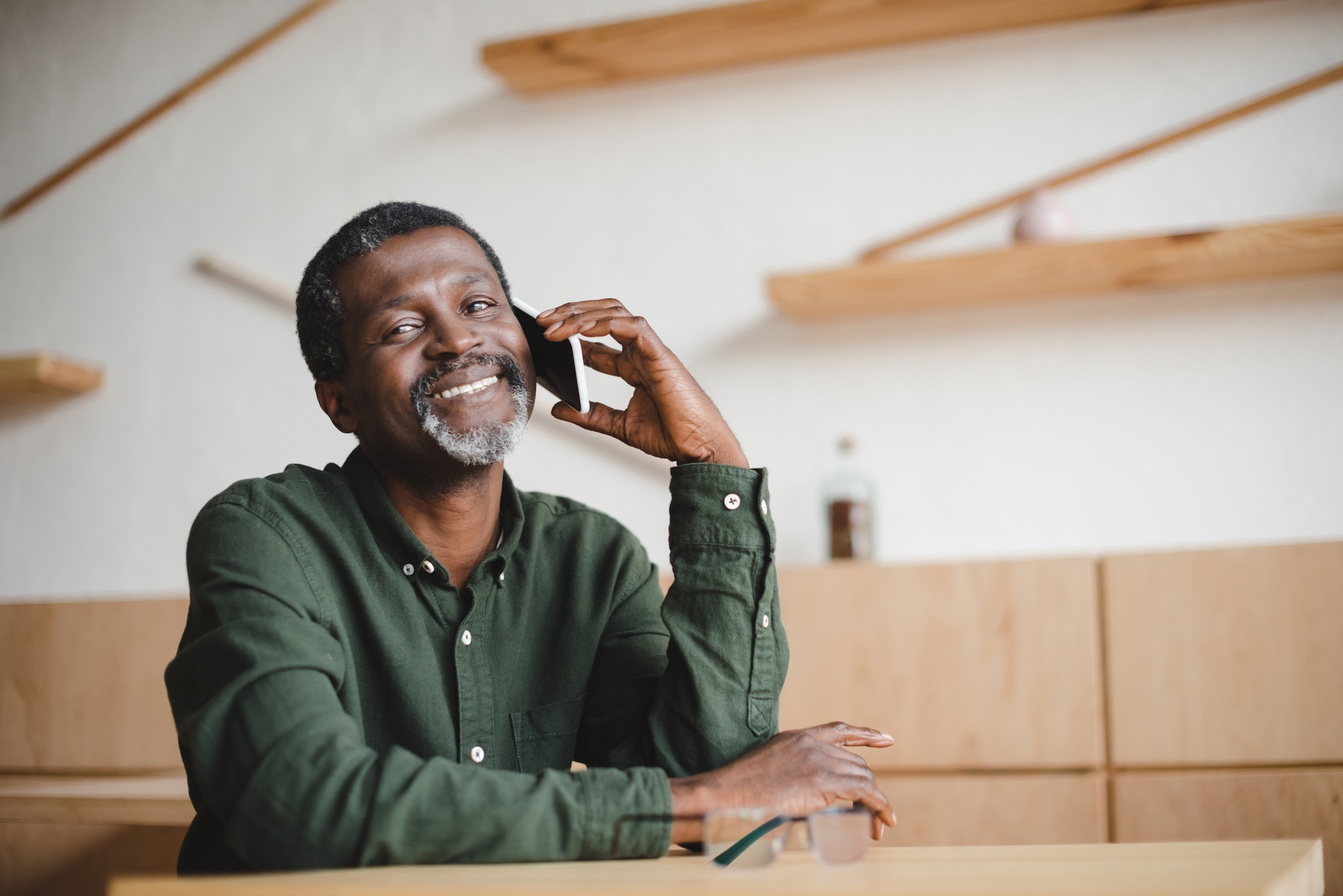 Man talking by phone in cafe