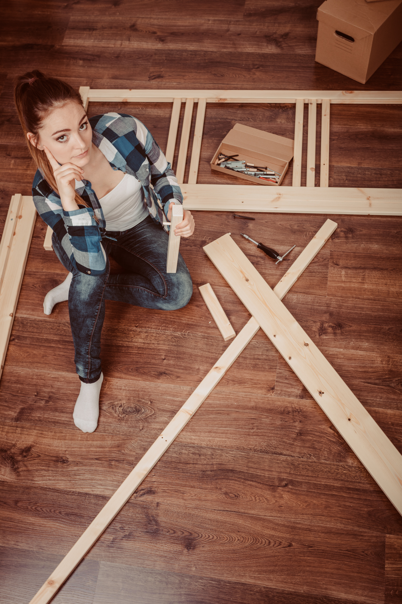 Woman assembling wood furniture-1